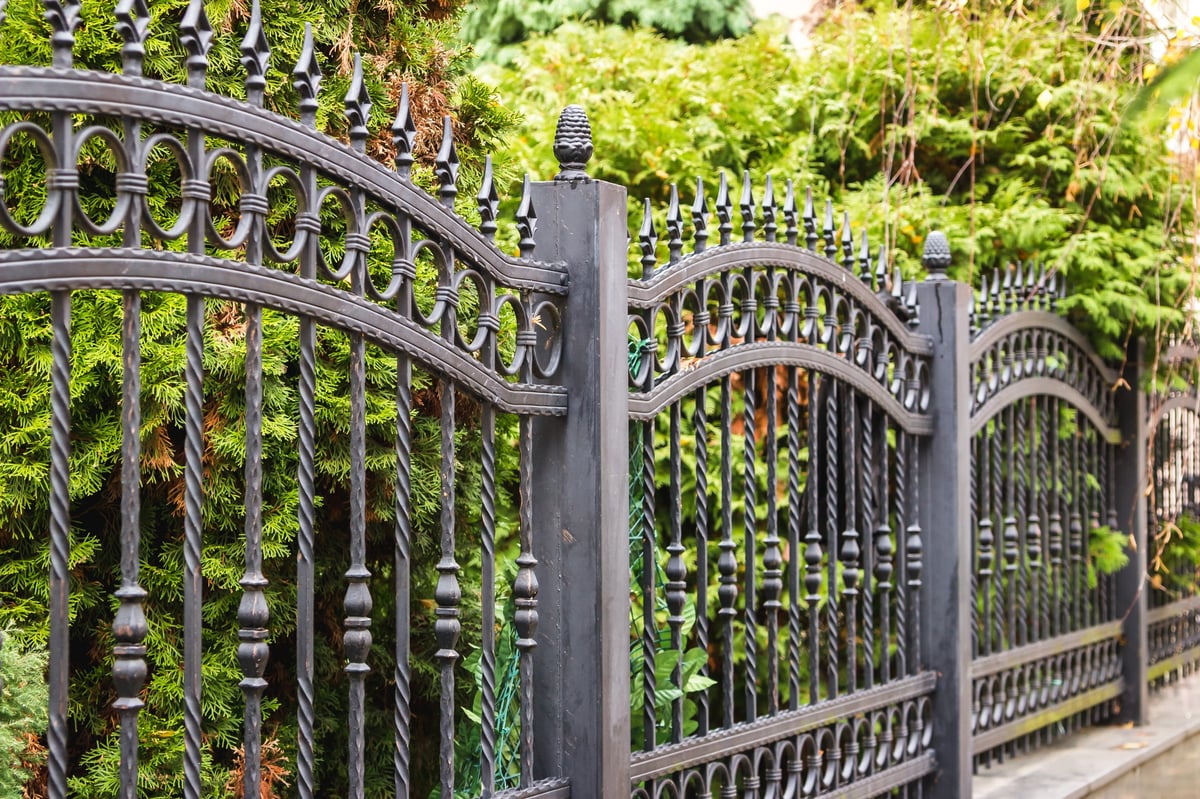Black iron fence panels on a Texas property