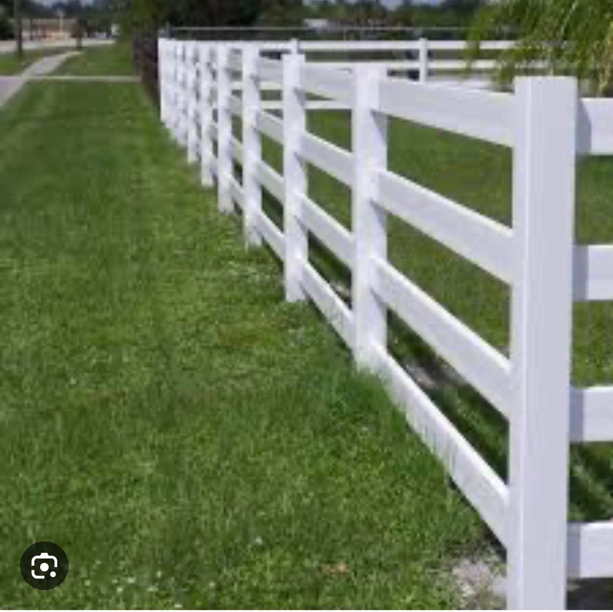 Long white vinyl ranch fence along a residential property boundary Brookshire TX