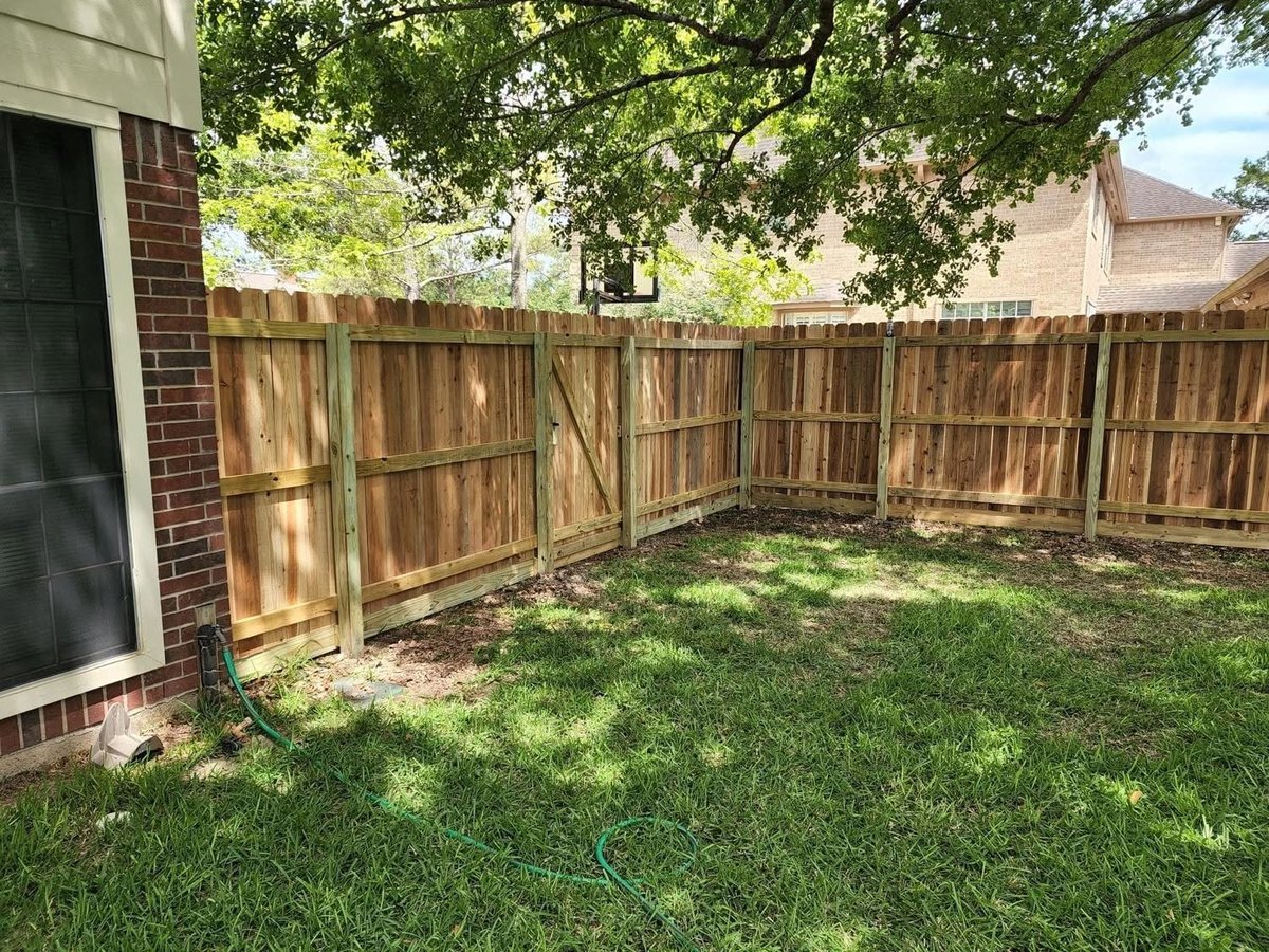 Residential backyard with wooden privacy fence Brookshire TX