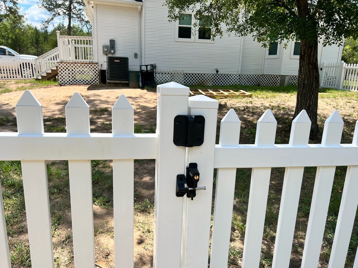 White picket fence gate with black mailbox in Brookshire TX